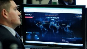 A Department of Homeland Security worker listens to U.S. President Barack Obama talk at the National Cybersecurity and Communications Integration Center in Arlington, Virginia, January 13, 2015.     REUTERS/Larry Downing   (UNITED STATES - Tags: POLITICS SCIENCE TECHNOLOGY CRIME LAW MILITARY) - RTR4LBMO