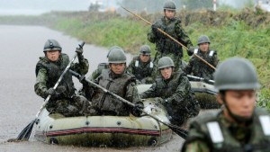 Japan Self-Defence Force soldiers search for missing people at an area hit by landslides caused by heavy rains in Aso, Kumamoto prefecture, in this photo taken by Kyodo July 14, 2012. Evacuation orders was issued to 40,000 people in Kyushu area due to heavy rain on Saturday, Kyodo news reported. MANDATORY CREDIT   REUTERS/Kyodo (JAPAN - Tags: DISASTER ENVIRONMENT MILITARY) FOR EDITORIAL USE ONLY. NOT FOR SALE FOR MARKETING OR ADVERTISING CAMPAIGNS. THIS IMAGE HAS BEEN SUPPLIED BY A THIRD PARTY. IT IS DISTRIBUTED, EXACTLY AS RECEIVED BY REUTERS, AS A SERVICE TO CLIENTS. MANDATORY CREDIT. JAPAN OUT. NO COMMERCIAL OR EDITORIAL SALES IN JAPAN - RTR34X2F