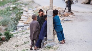 Young boys hide their faces after having a camera pointed at them by a photographer embedded with soldiers from 4th Platoon, Dagger Company of the 2nd Battalion, 12th Infantry Regiment walk through their village of Manugay in the Pech River Valley of Afghanistan's Kunar Province June 26, 2012.  REUTERS/Lucas Jackson  (AFGHANISTAN - Tags: CIVIL UNREST MILITARY) - RTR34DH5